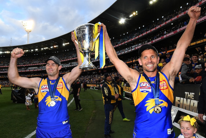 Shannon Hurn and Mark LeCras lift the premiership cup