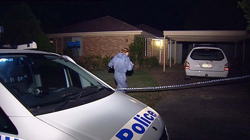 Police enter the house at Sunnybank where the bodies of 18-month-old twins were found.