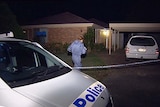 Police enter the house at Sunnybank where the bodies of 18-month-old twins were found.