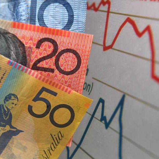 Australian currency is seen next to a wages graph