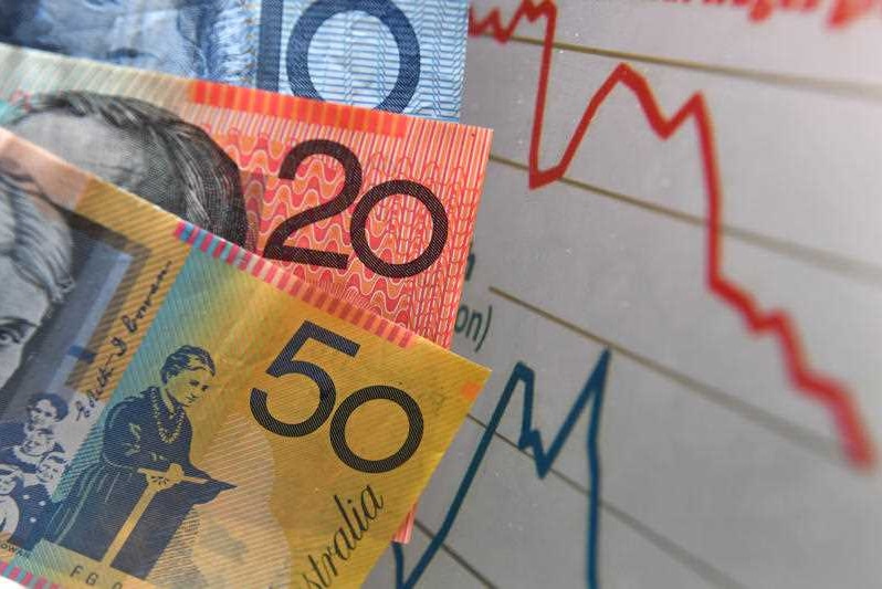 Australian currency is seen next to a wages graph