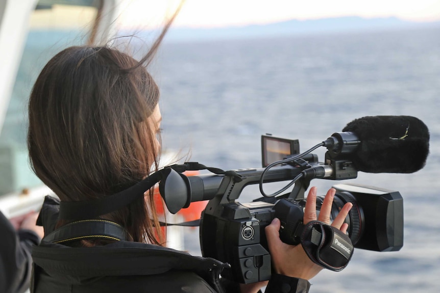 ABC reporter Rhiannon Shine at work on board RV Investigator.