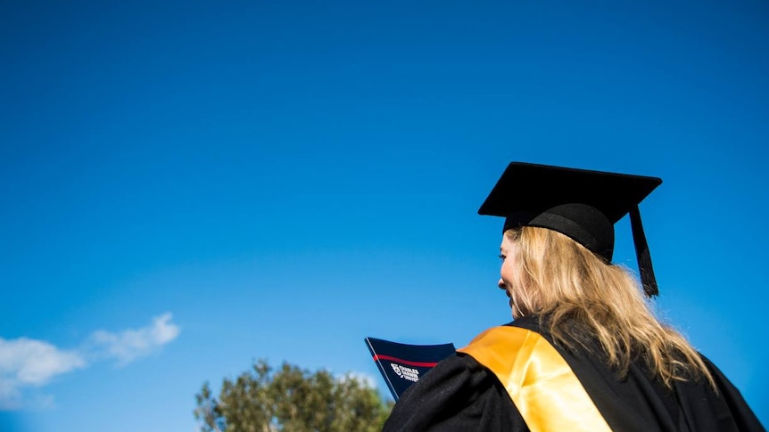 A student at Charles Darwin University heads to a 2016 graduation ceremony.