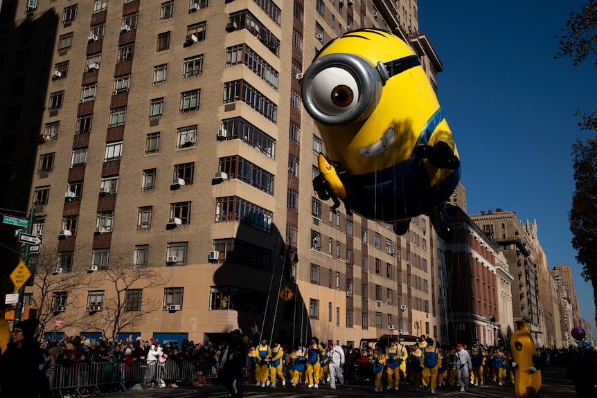 Handlers pull the Stuart the Minion balloon along Central Park West