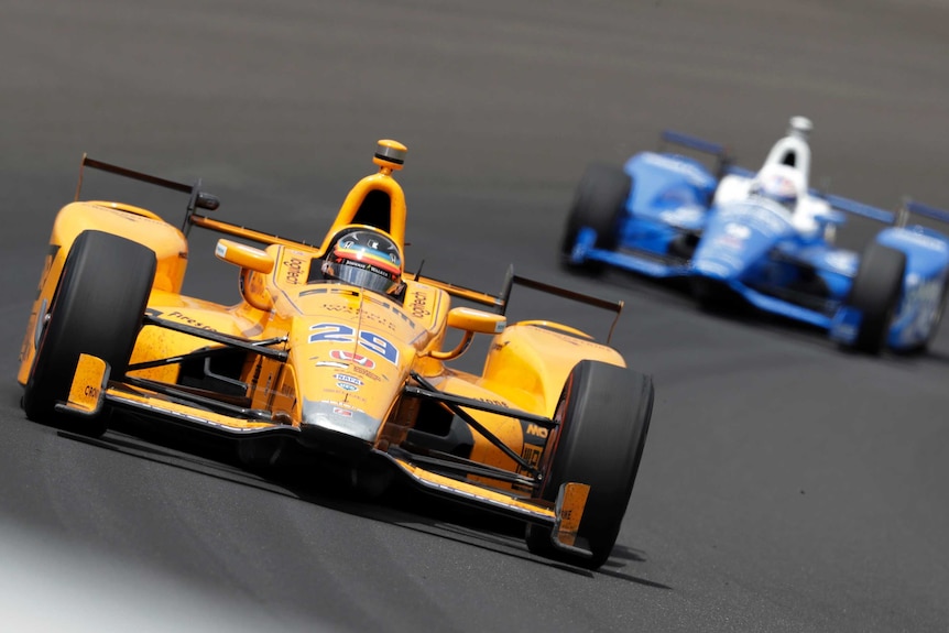 Fernando Alonso, of Spain, makes his way through the first turn during the running of the Indianapolis 500 auto race.