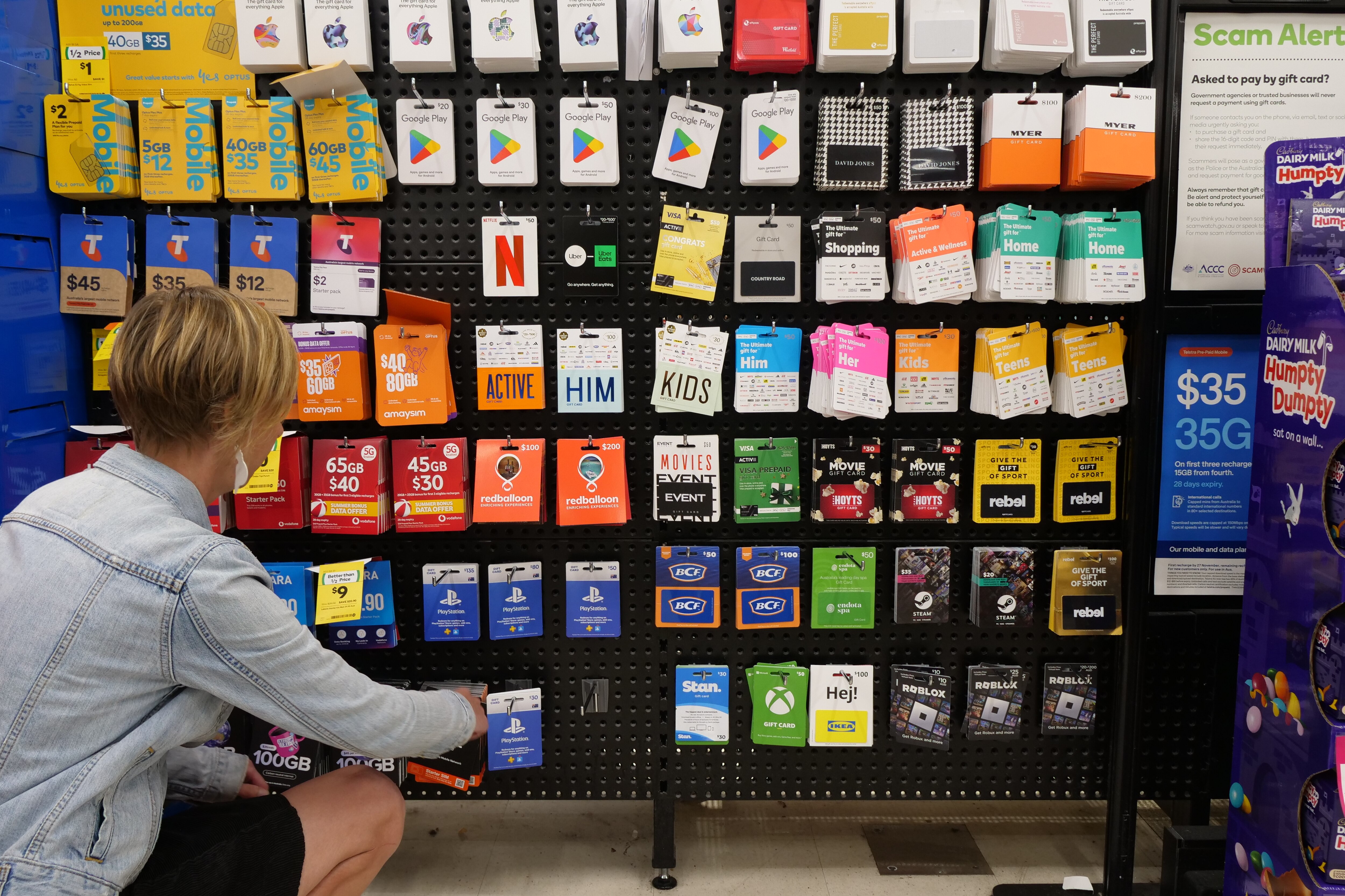 Rows of gift cards on a wall at a supermarket
