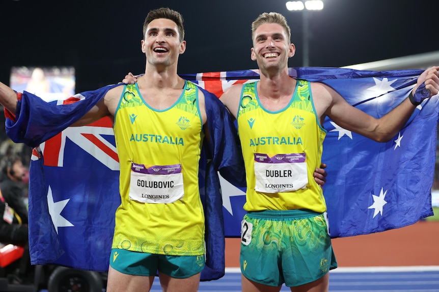 Dan Golubovic and Cedric Dubler hold the flag