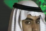 A wanted poster showing Hamza bin Laden's face.