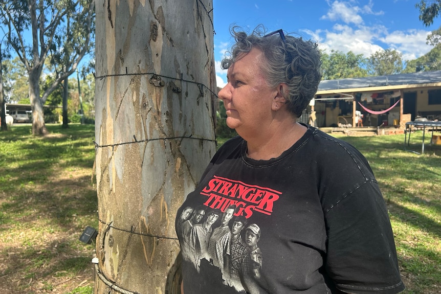 Woman looks out on property. 