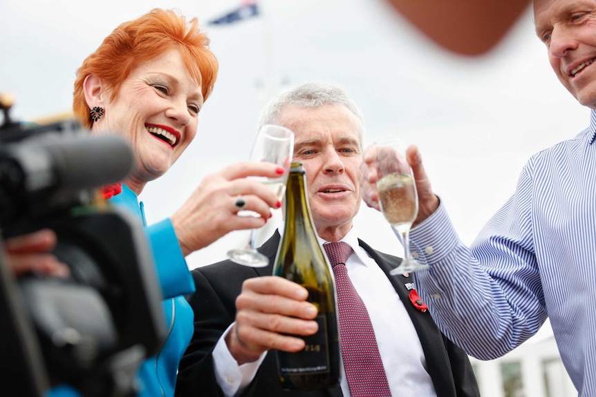 One Nation Senators drink champagne outside Parliament House