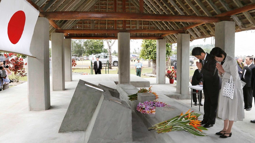 Japanese Prime Minister Shinzo Abe and his wife visit a World War II memorial in PNG
