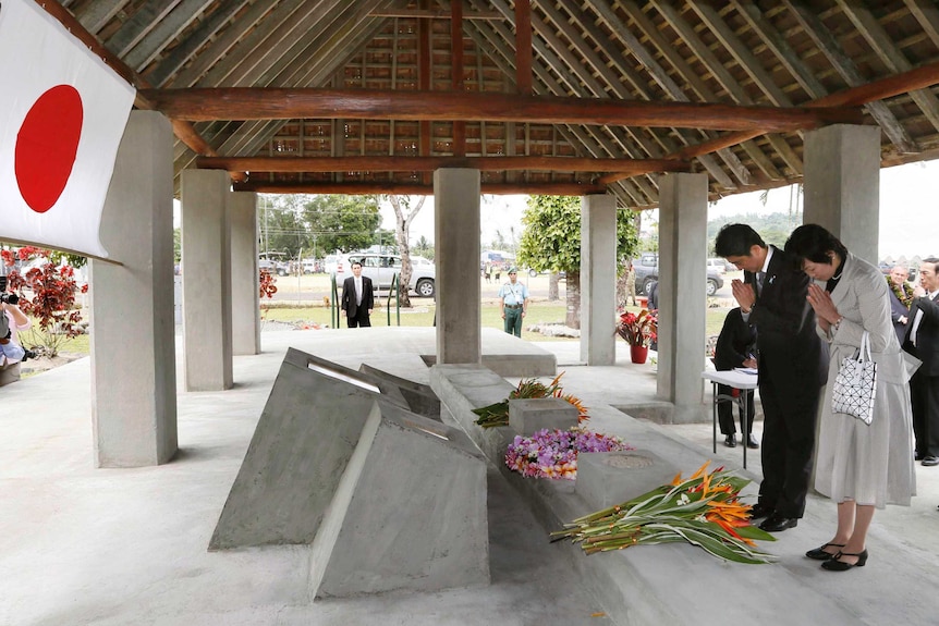 Japanese Prime Minister Shinzo Abe and his wife visit a World War II memorial in PNG