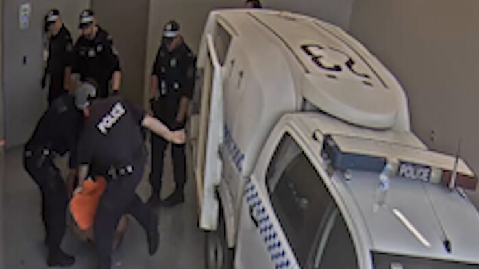 CCTV footage of a police officer allegedly kicking Carl Hoppner at Toronto Police Station.