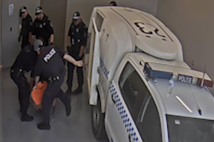 CCTV footage of a police officer allegedly kicking Carl Hoppner at Toronto Police Station.
