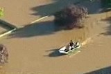 A speed boat makes its way through floodwaters in Wagga Wagga.