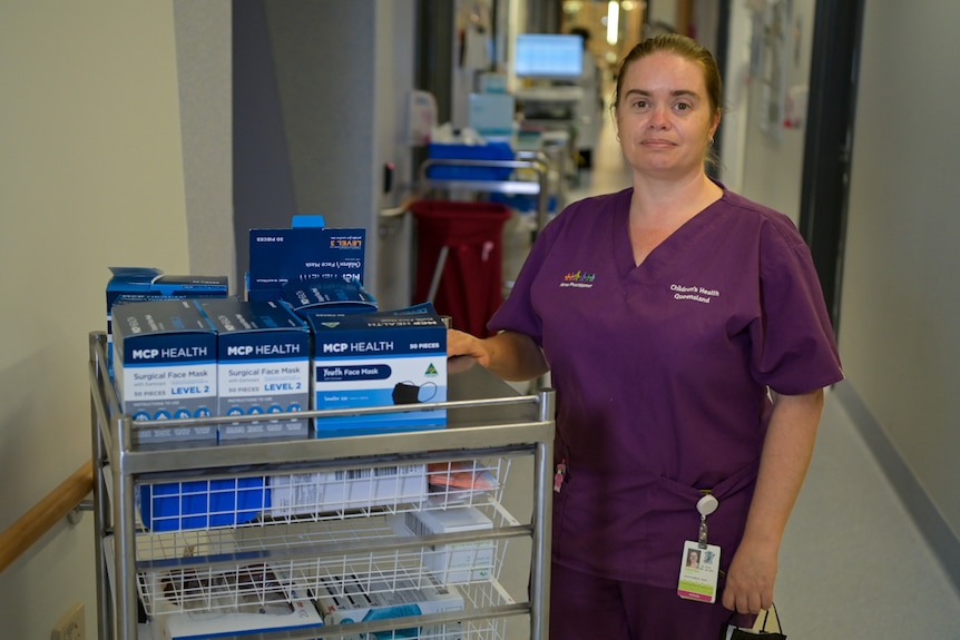 Nurse practitioner Kristen Storey in scrubs with medication.