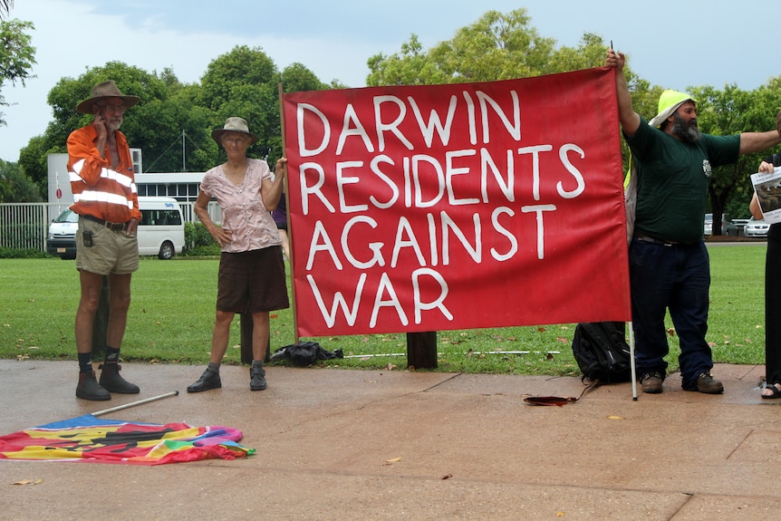 Demonstrators gather outside of the NT Parliament House to protest ahead of the visit.