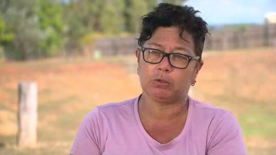 Woman wearing glasses lookes into camera while speaking. 