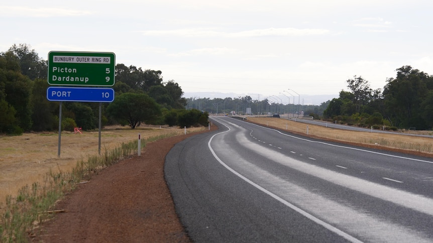 A road with a sign pointing to the Bunbury Outer Ring Road
