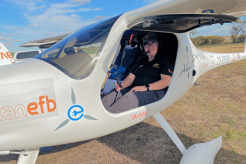 A woman sits in a light plane.