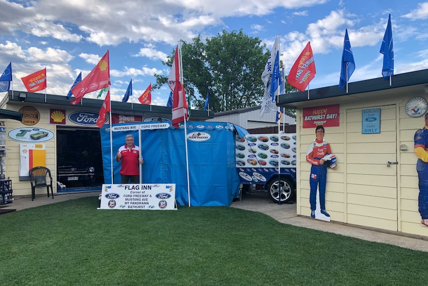 A man stands in his backyard which he's made into a shrine to the Bathurst 1000.