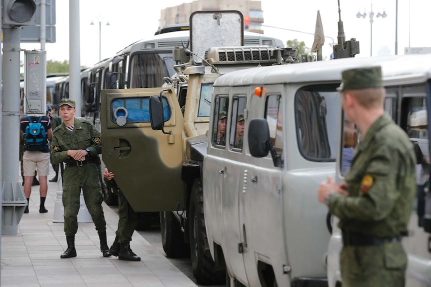 Russian Interior Ministry buses and cars parked in Tverskaya Street with officials in uniform standing outside