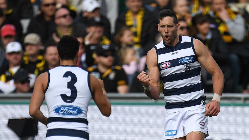 Harry Taylor gives a fist pump after kicking a goal for the Cats.