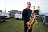 Ocean Alley's saxophone player warms up backstage in the carpark.