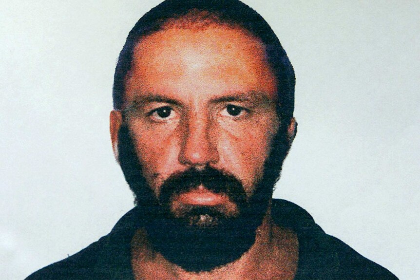 Mugshot of Robert Paul Long in 2000. Man wears crew cut and thick beard and looks directly at camera