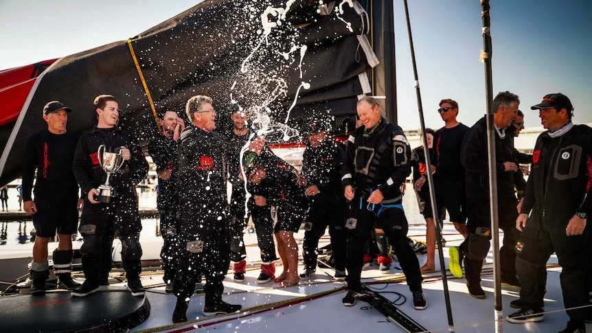 Comanche crew celebrating after winning the 75th Sydney to Hobart race.