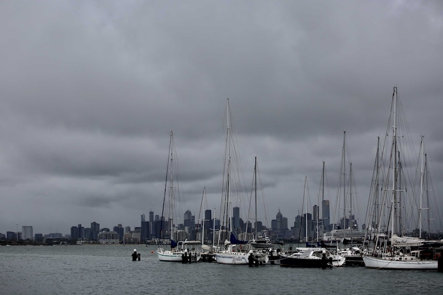 The Melbourne skyline looks ominous from Williamstown.