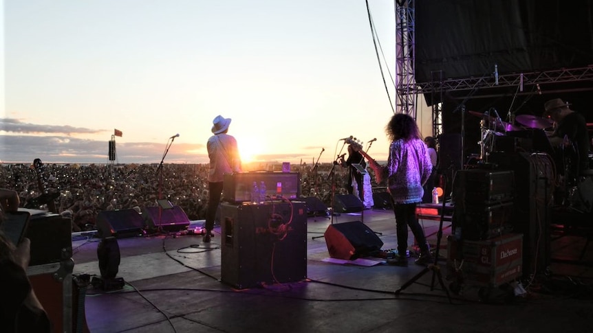 Musicians on stage during a music festival.