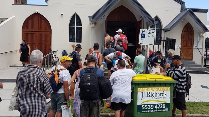 People line-up at the soup kitchen at St John's Crisis Centre in Surfers Paradise