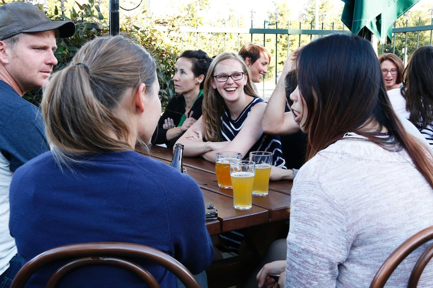 A group of friends catch up for a drink at a Canberra pub.