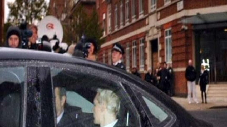 Julian Assange arrived at the London court by car but left in a prison van.