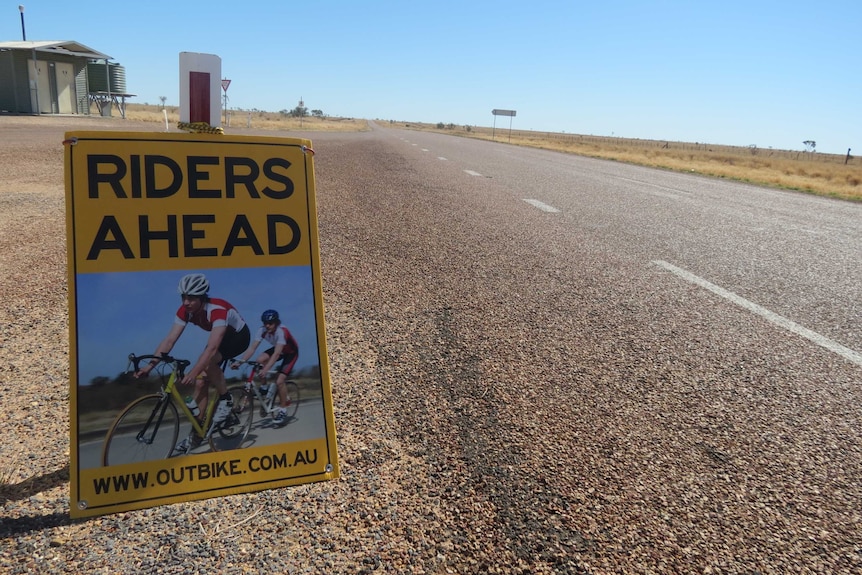 A sign warns drivers of cyclists ahead during an outback Qld ride.