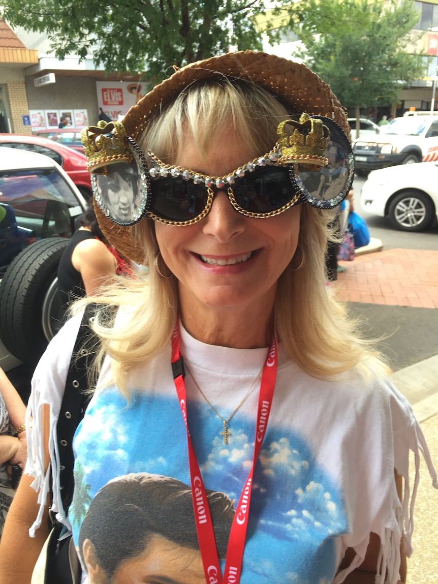 A woman with big Elvis Presley sunglasses and Elvis T shirt