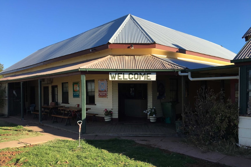 Old single-storey hotel with shady verandas.