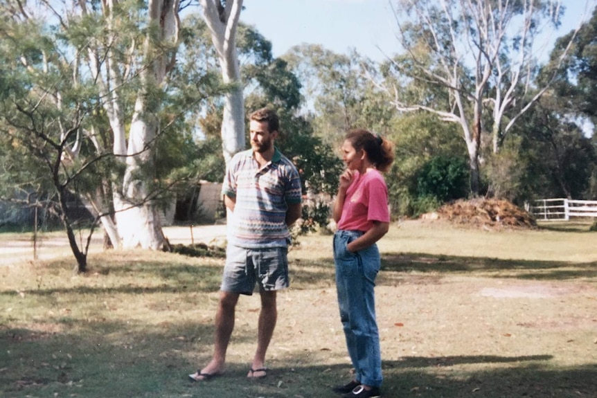 Michael Devitt stands with his sister-in-law Mischelle in a paddock at a family property in Queensland, date unknown.