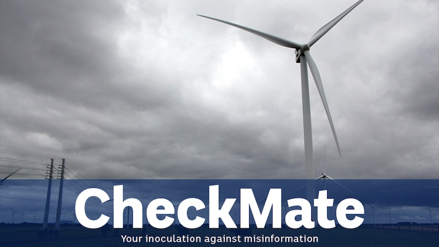 A wind turbine against a grey sky. Caption underneath says CHECKMATE on a transparent blue background