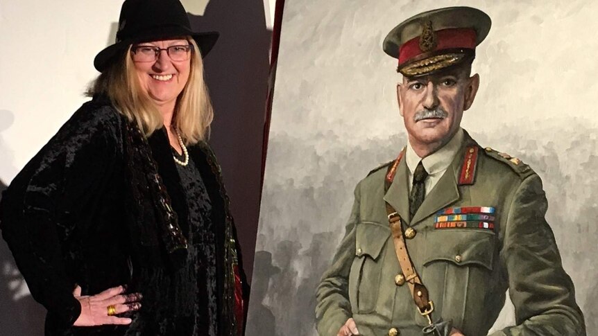 A woman in a hat stands next to a painting of a military man.