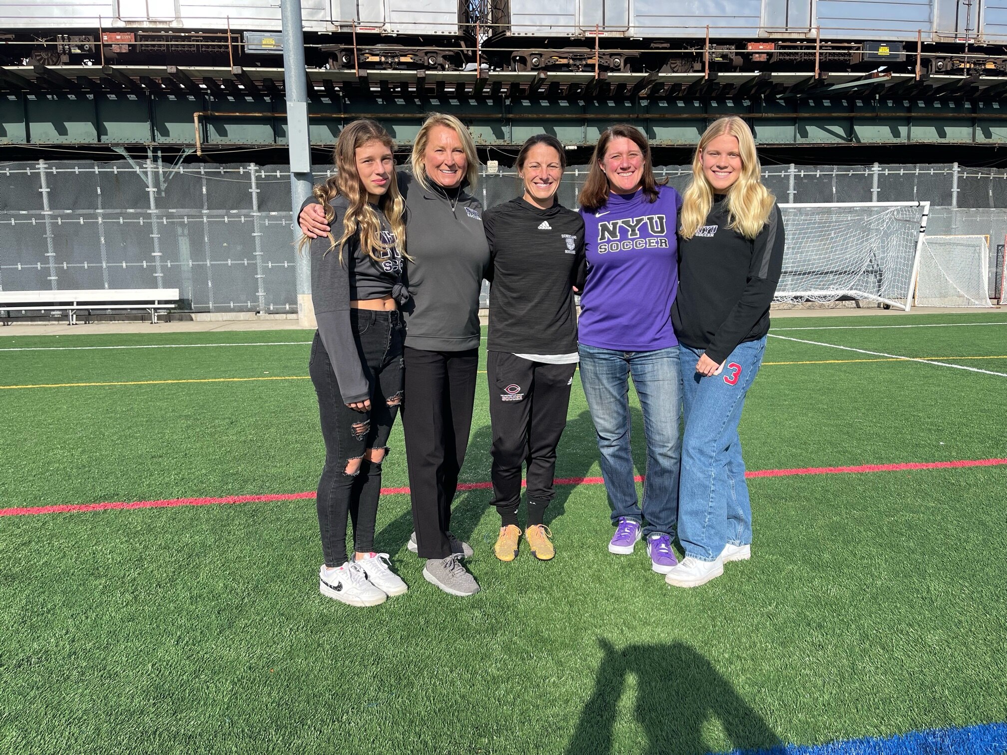 Two women head coaches pose for photos with their children
