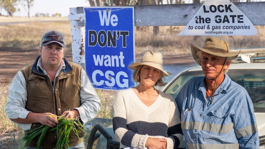 Three farmers in farming clothes stand side by side