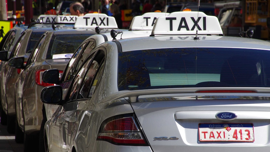 Silver taxi's lining up in row in Perth