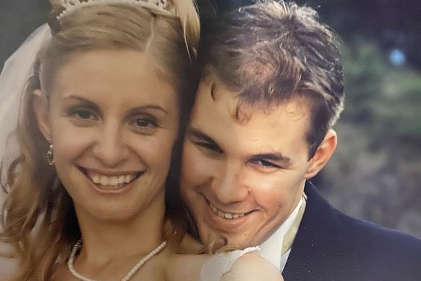 An old wedding photo of Kelli and Matt smiling.