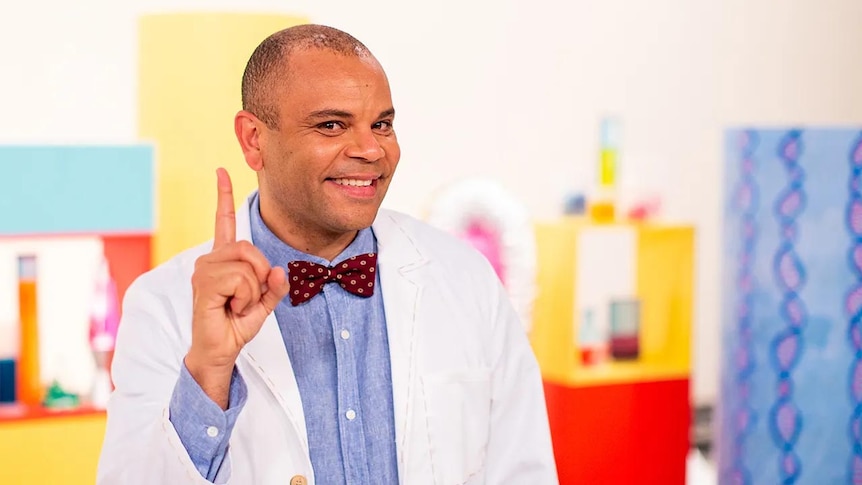 Luke wearing a lab coat on the Play School Science Time set