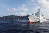 A Japanese Coast Guard vessel sails in front of one of the disputed islands in the East China Sea.