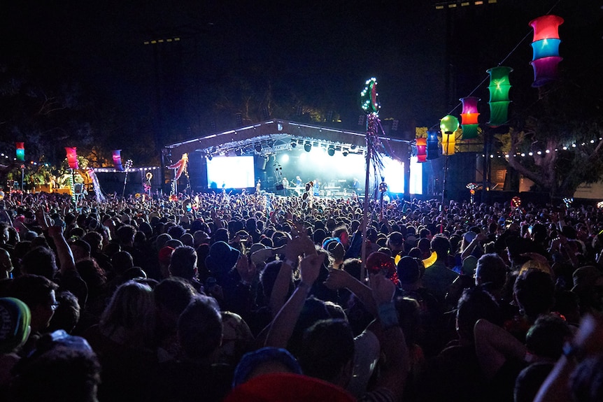 The crowd at night time at Golden Plains, photo taken from behind, facing the stage.