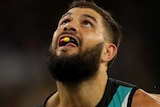 Paddy Ryder stands with his right hand outstretched looking up at the sky with Nathan Vardy behind him.