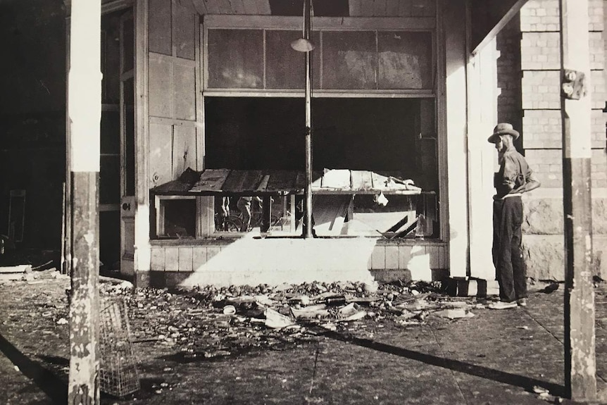 A man surveys the ruins of the Majestic Cafe in Kalgoorlie, 1934.